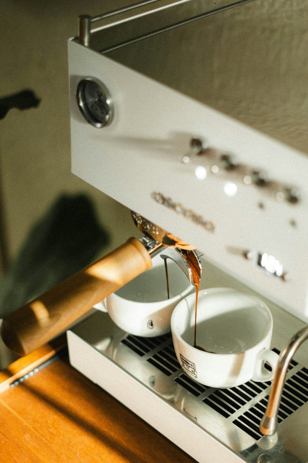 Espresso machine pouring 2 espresso shots into small mugs